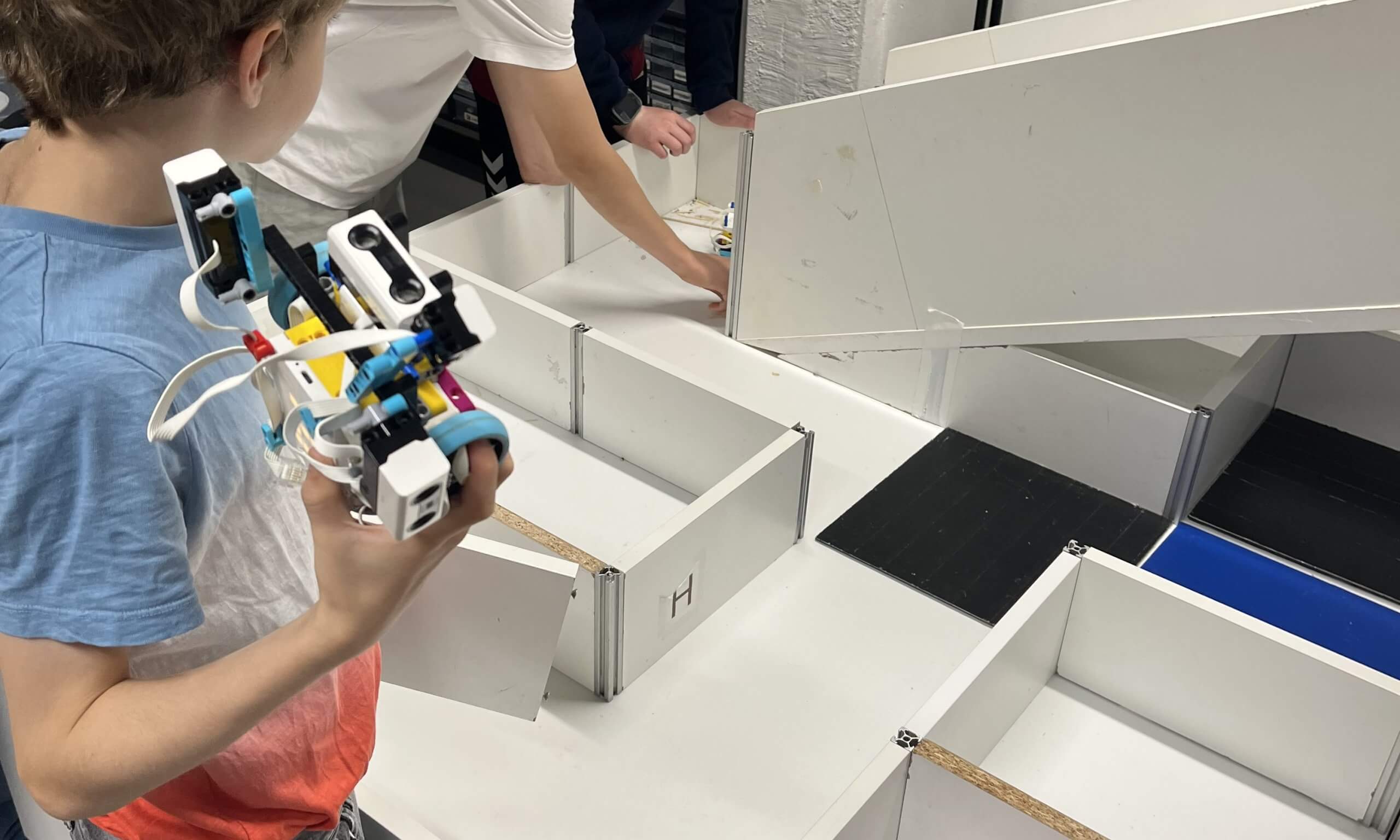 LEGO SPIKE Feriencamp Herbstferien 2027 Kinder testen einen selbst gebauten LEGO-SPIKE-Roboter